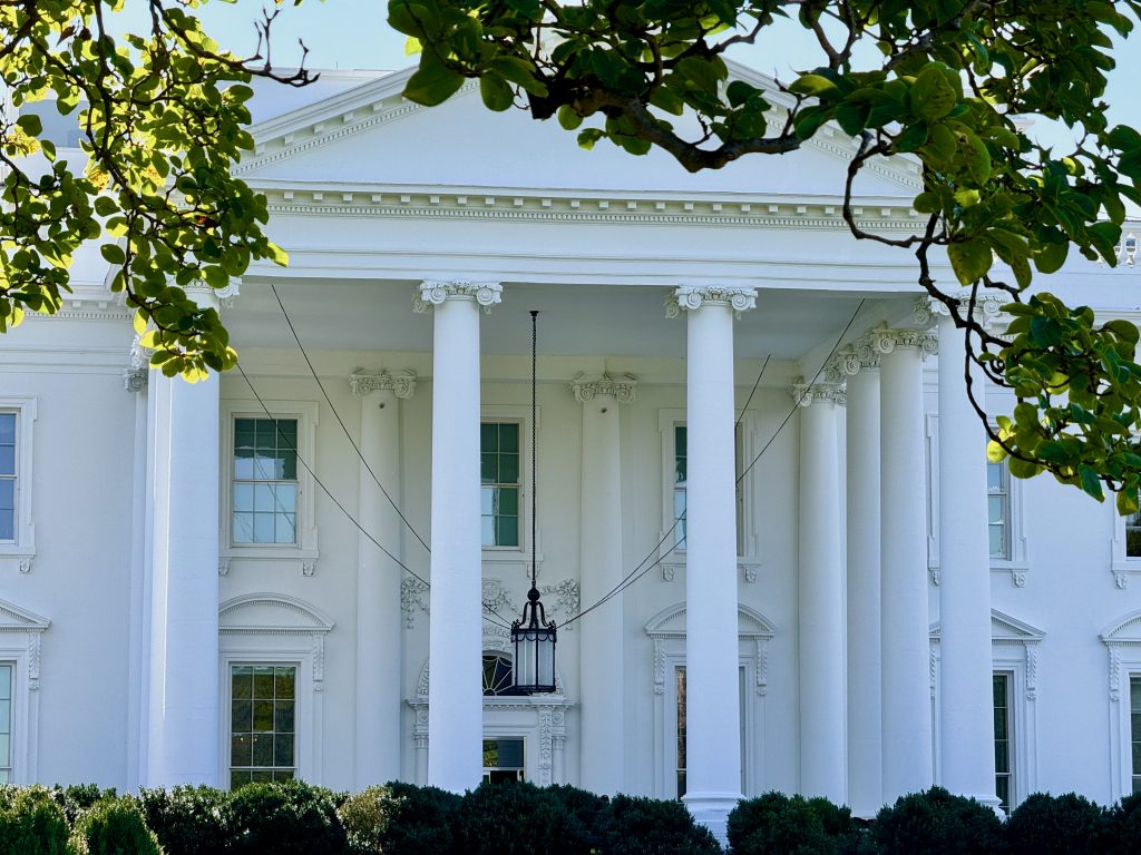 The North Portico of the White House framed by magnolia leaves