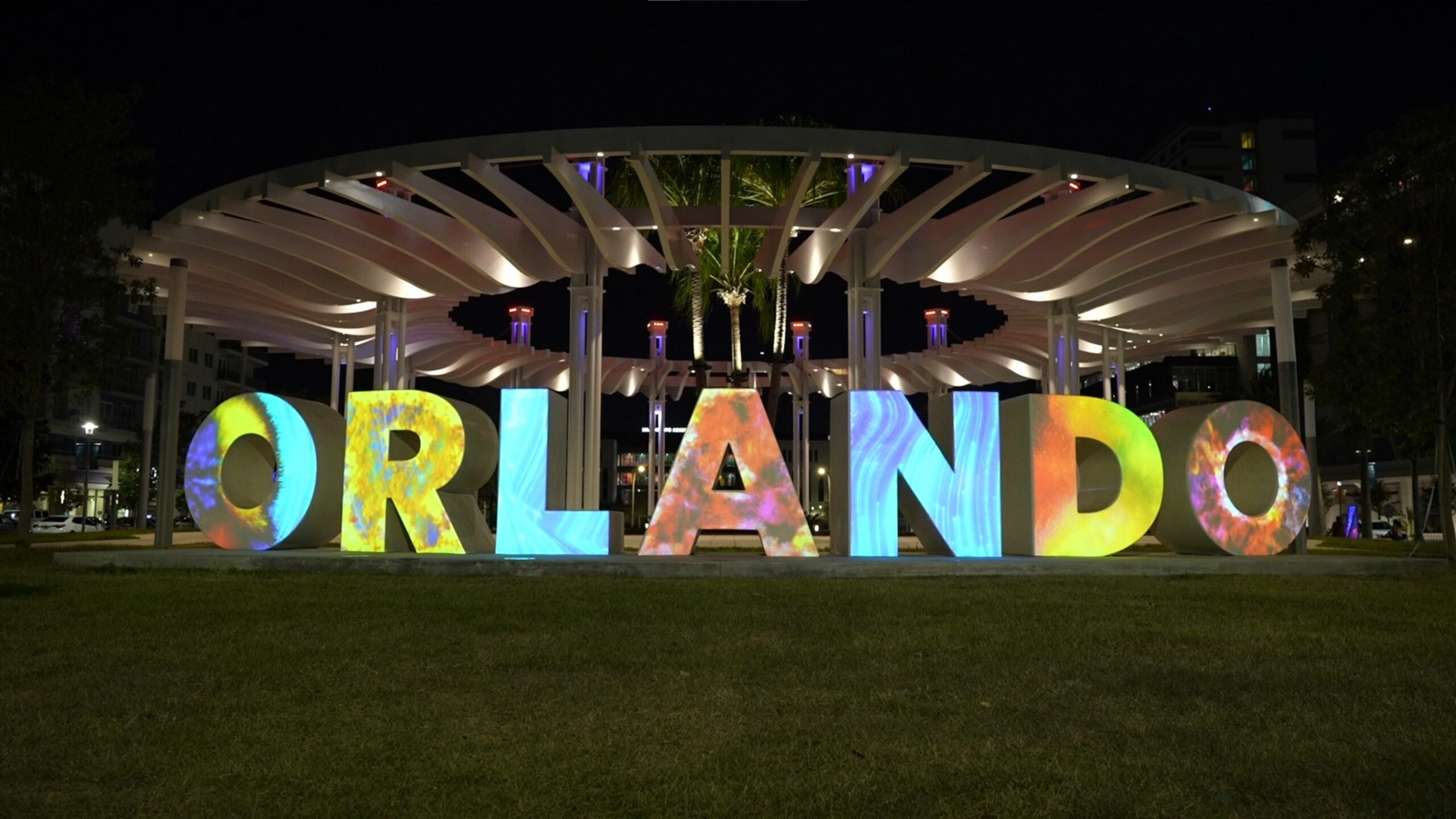 Illuminated ORLANDO letters at Luminary Green park at night